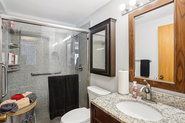 full bath with a stall shower, vanity, and toilet