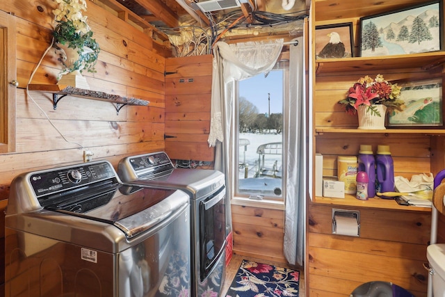 laundry room featuring laundry area, independent washer and dryer, visible vents, and wooden walls