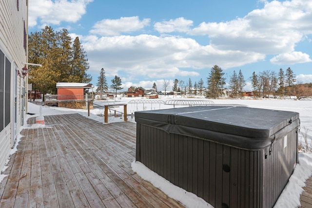 snow covered deck with a hot tub