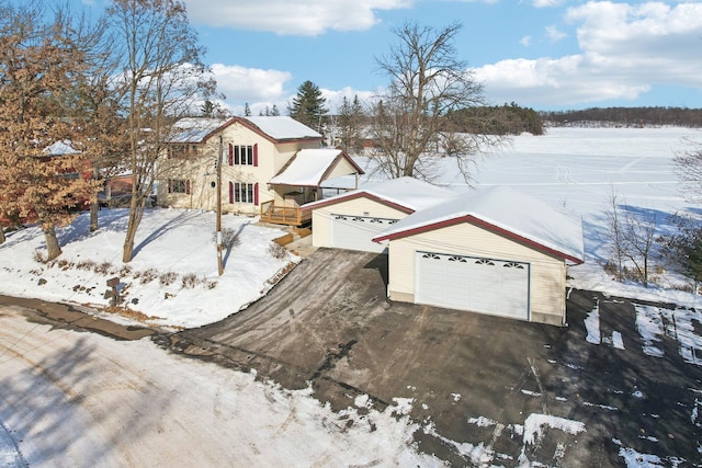 view of front of property featuring a garage and an outdoor structure