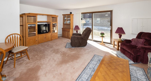 living room featuring a baseboard heating unit and light carpet