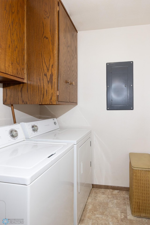 laundry area featuring electric panel, cabinet space, baseboards, and washing machine and clothes dryer