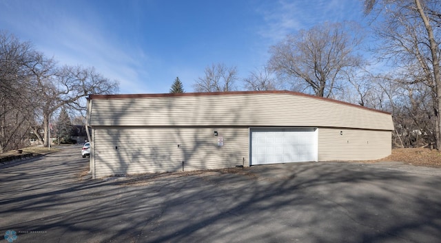 garage with aphalt driveway