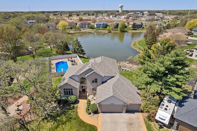 drone / aerial view with a water view and a residential view