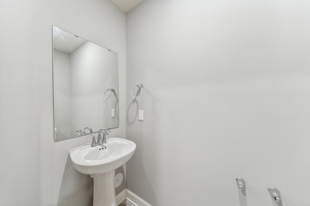 bathroom featuring a sink and baseboards