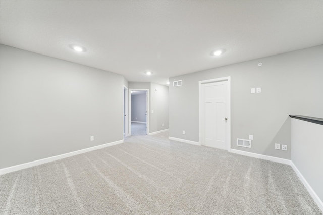 unfurnished room featuring recessed lighting, carpet flooring, visible vents, and baseboards