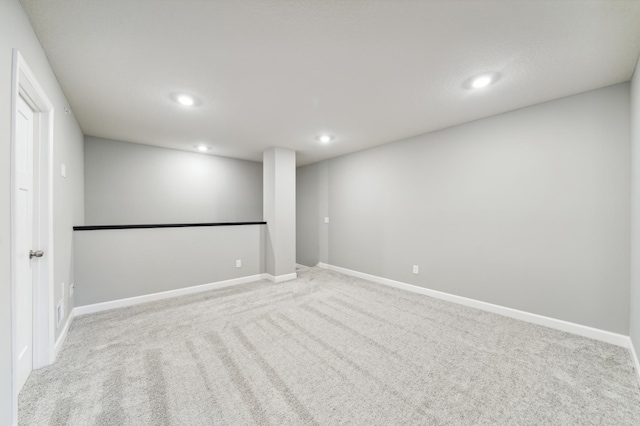 spare room featuring recessed lighting, carpet flooring, and baseboards