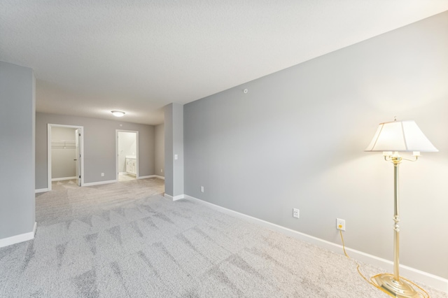 unfurnished room with carpet floors and baseboards