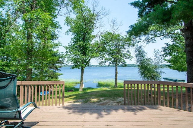 wooden terrace featuring a water view