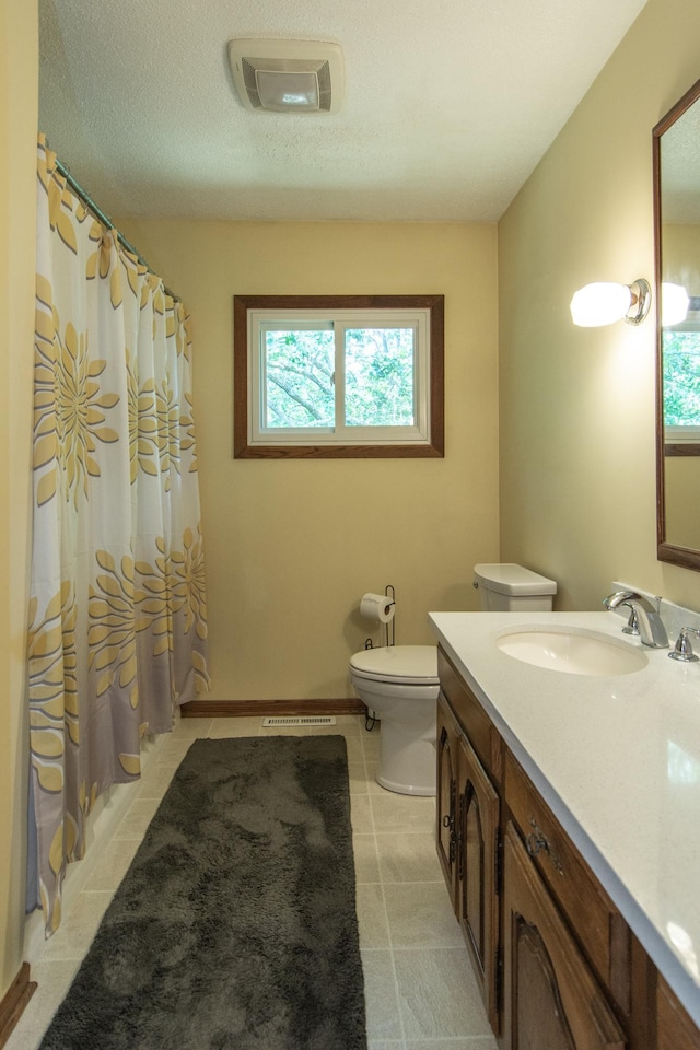 full bathroom featuring visible vents, toilet, tile patterned flooring, a textured ceiling, and vanity