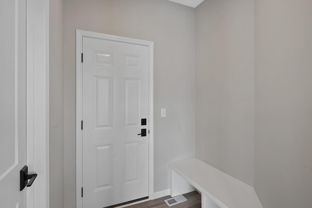 interior space featuring dark wood-type flooring and visible vents