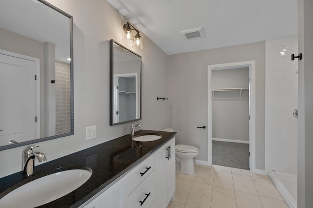 full bathroom with toilet, marble finish floor, a sink, and visible vents