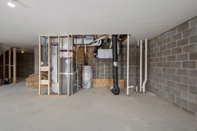 unfinished below grade area featuring concrete block wall and gas water heater