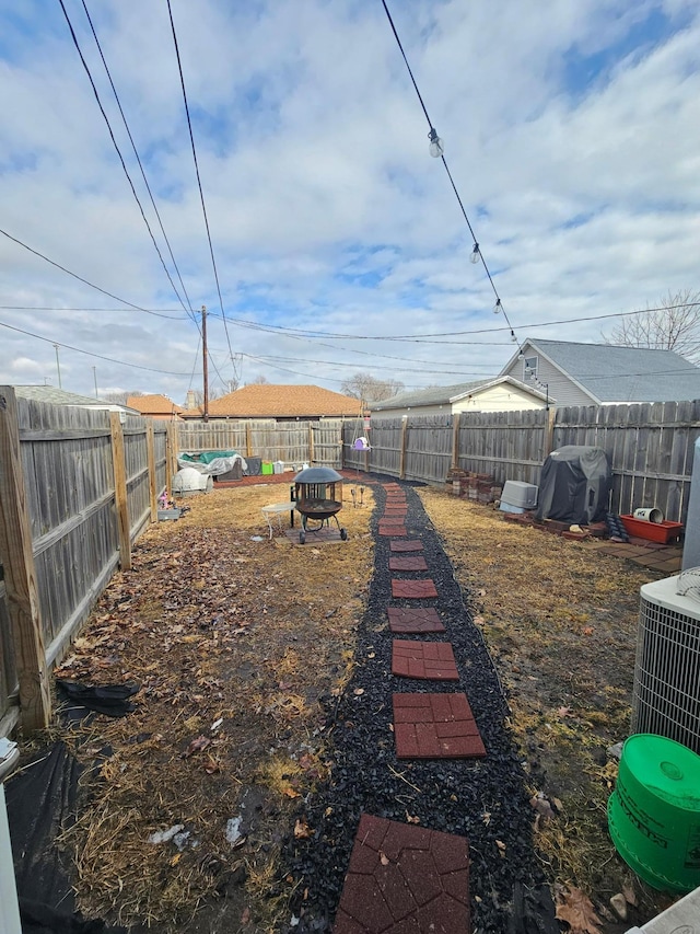 view of yard featuring central air condition unit and a fenced backyard