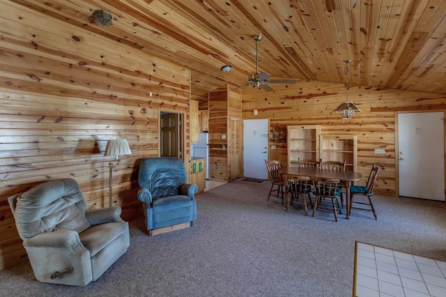 dining area featuring wooden walls, lofted ceiling, wooden ceiling, ceiling fan, and carpet floors