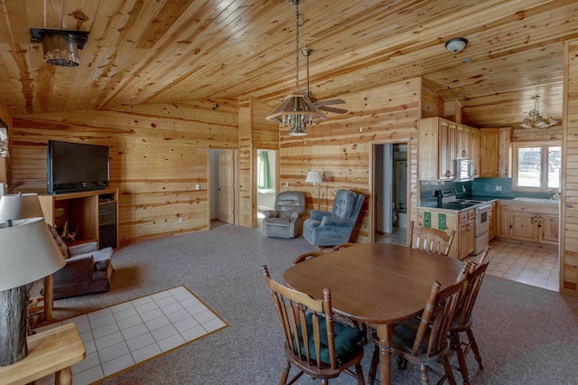 dining room featuring lofted ceiling, wood ceiling, and wooden walls