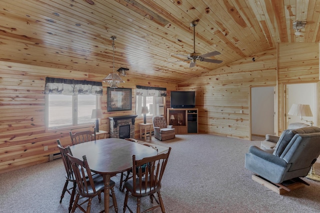 carpeted dining space with vaulted ceiling, a stone fireplace, wooden ceiling, and wooden walls