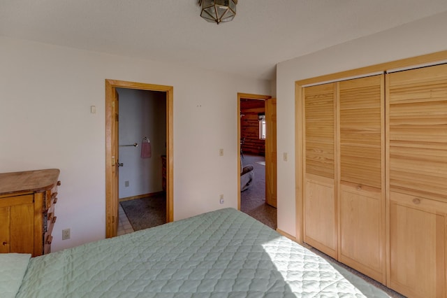 bedroom with a closet and ensuite bath