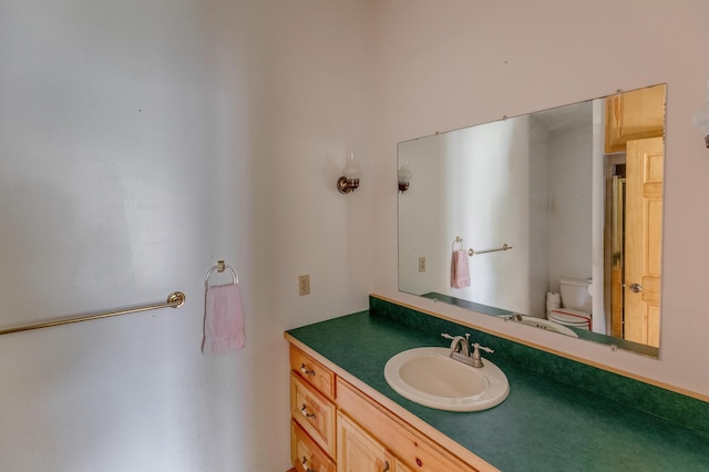 bathroom featuring vanity and toilet