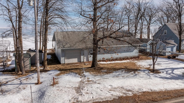 yard covered in snow featuring an attached garage