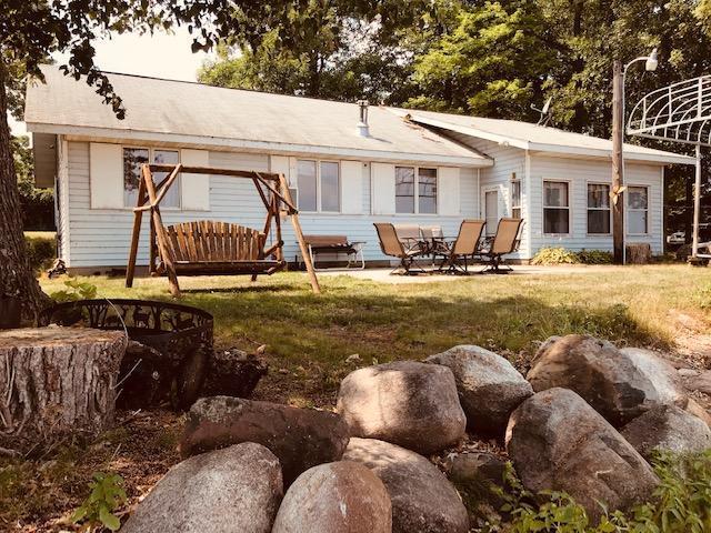 back of property with a patio area and a lawn