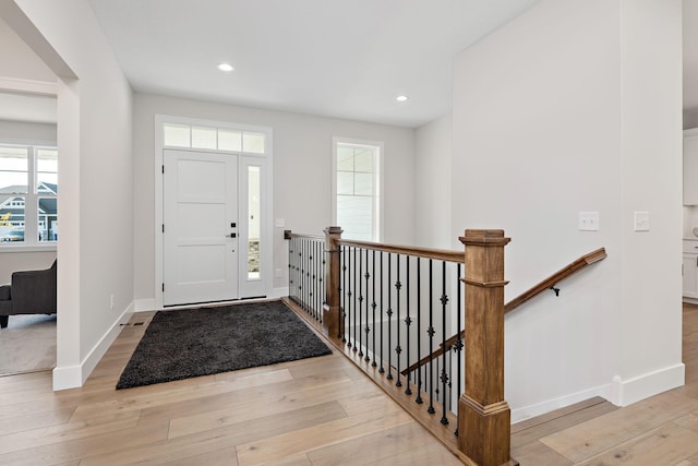 entrance foyer featuring light wood-type flooring, baseboards, and recessed lighting