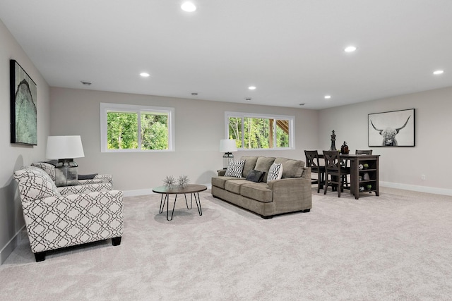 carpeted living room featuring baseboards and recessed lighting