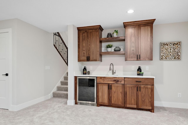 bar featuring beverage cooler, light carpet, a sink, and stairs