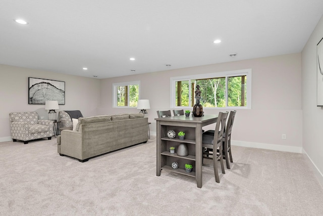 living room featuring recessed lighting, baseboards, and light colored carpet