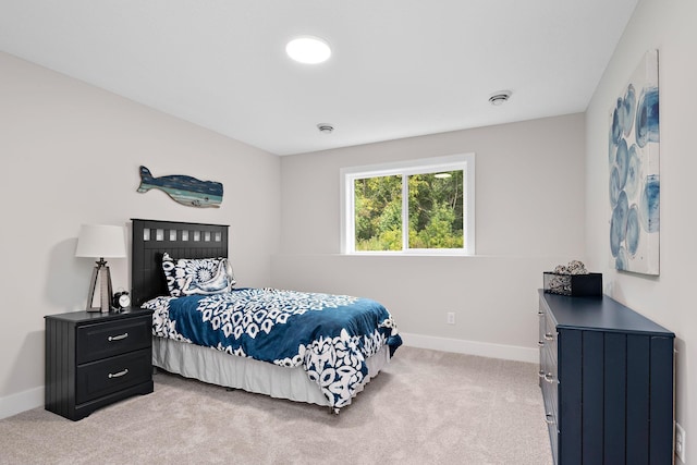 bedroom featuring baseboards and light colored carpet