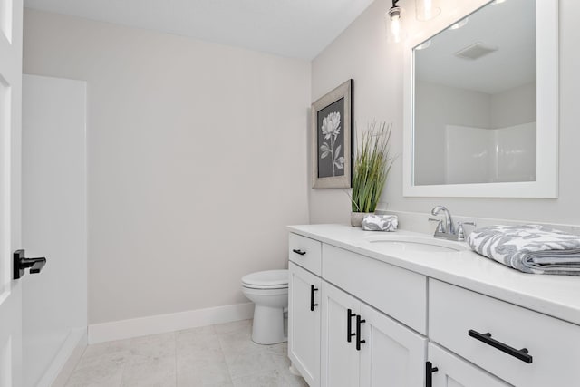 bathroom with toilet, vanity, tile patterned flooring, baseboards, and walk in shower