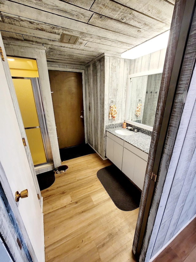 bathroom with visible vents, wood finished floors, and vanity