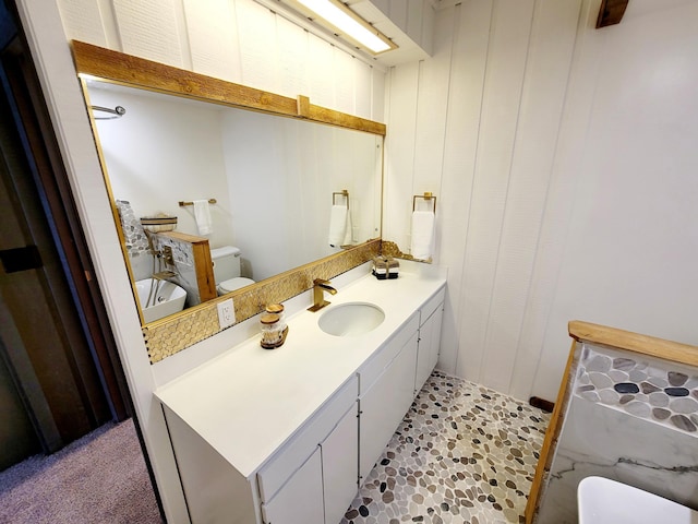 bathroom featuring vanity and toilet