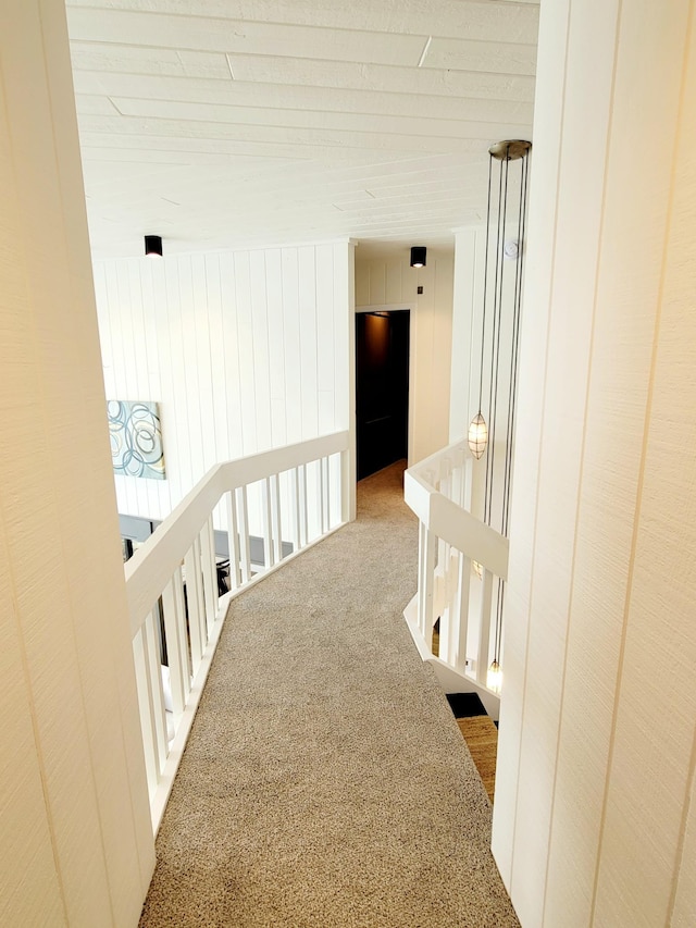 hallway featuring carpet and an upstairs landing