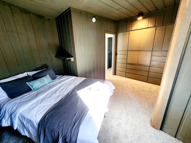 bedroom featuring wooden walls, carpet floors, and wood ceiling