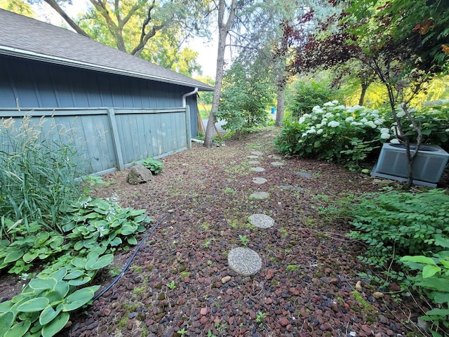 view of yard with central air condition unit
