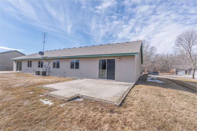 back of house with a yard and a patio