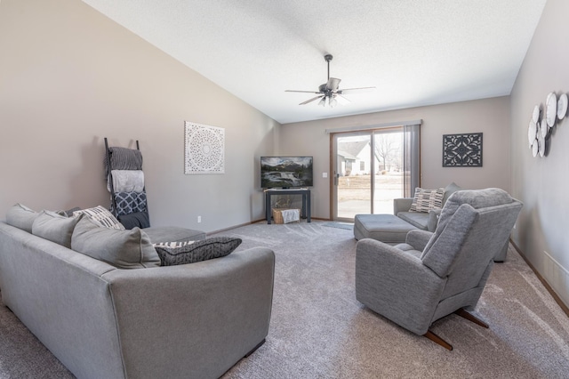 living room with baseboards, a ceiling fan, vaulted ceiling, a textured ceiling, and carpet floors