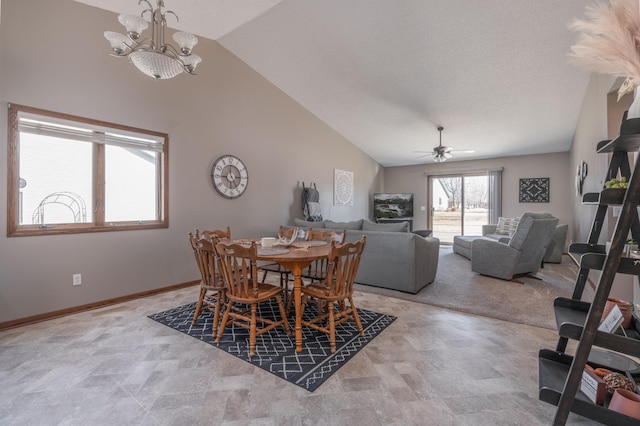 dining area featuring high vaulted ceiling, baseboards, and ceiling fan with notable chandelier