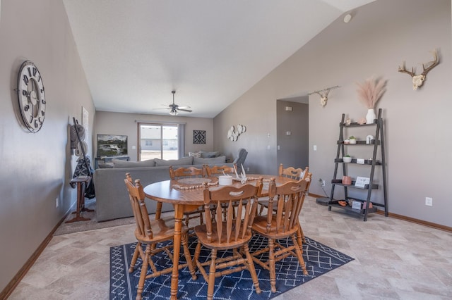 dining area with vaulted ceiling, a ceiling fan, and baseboards