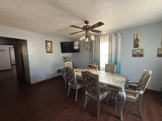 dining room featuring ceiling fan, a textured ceiling, baseboards, and wood finished floors