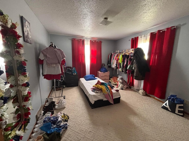 carpeted bedroom featuring a textured ceiling