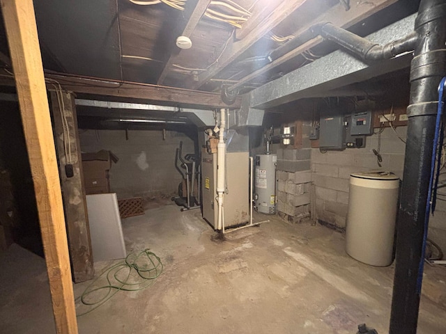 unfinished below grade area featuring water heater, electric panel, and heating unit