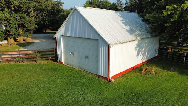 detached garage with driveway and fence