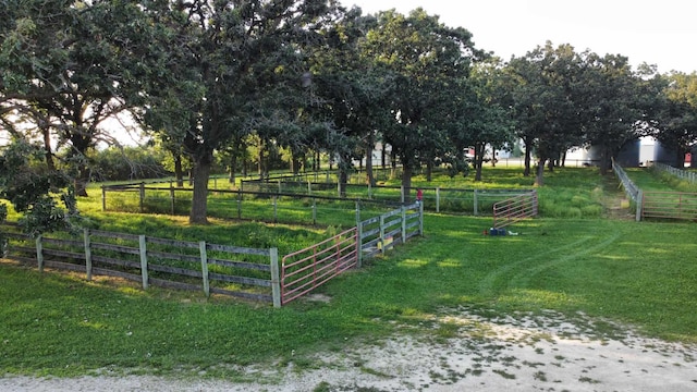 view of gate featuring a yard, a rural view, and fence