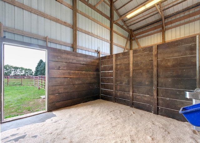 view of horse barn with a rural view