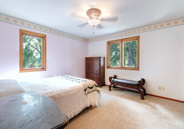 bedroom featuring carpet, multiple windows, and baseboards