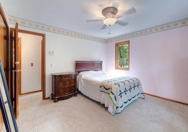 bedroom featuring ceiling fan, baseboards, and light colored carpet