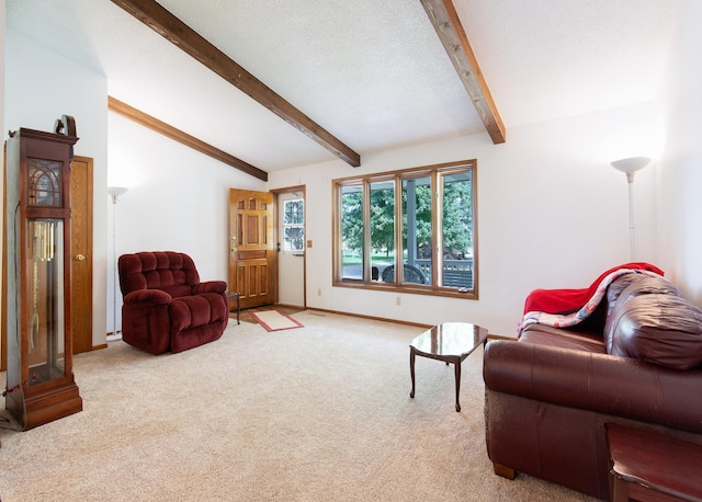 living room with lofted ceiling with beams, a textured ceiling, carpet flooring, and baseboards