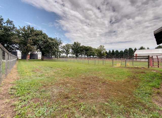 view of yard with a rural view and fence